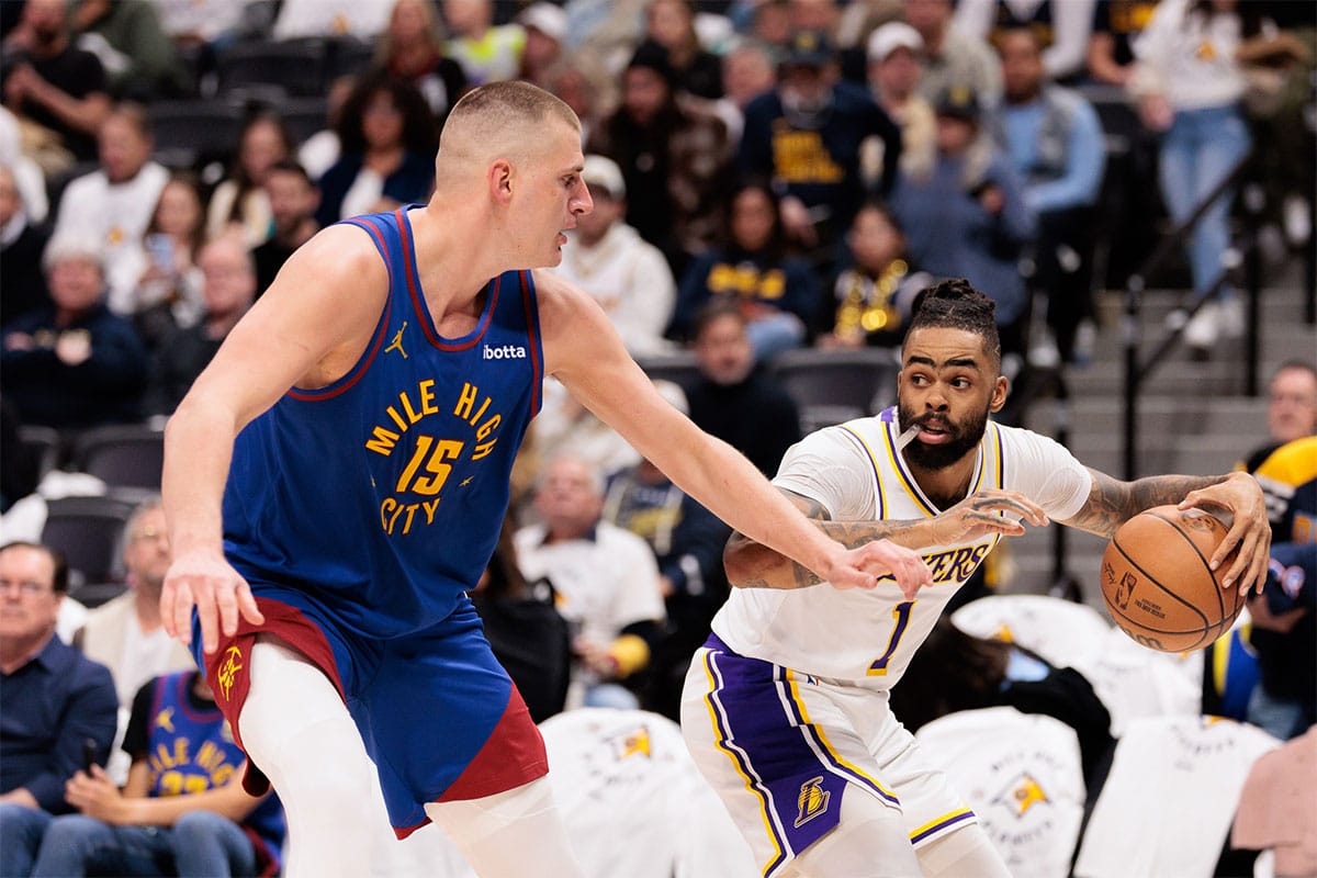 Los Angeles Lakers player D'Angelo Russell guarded by Denver Nuggets player Nikola Jokic