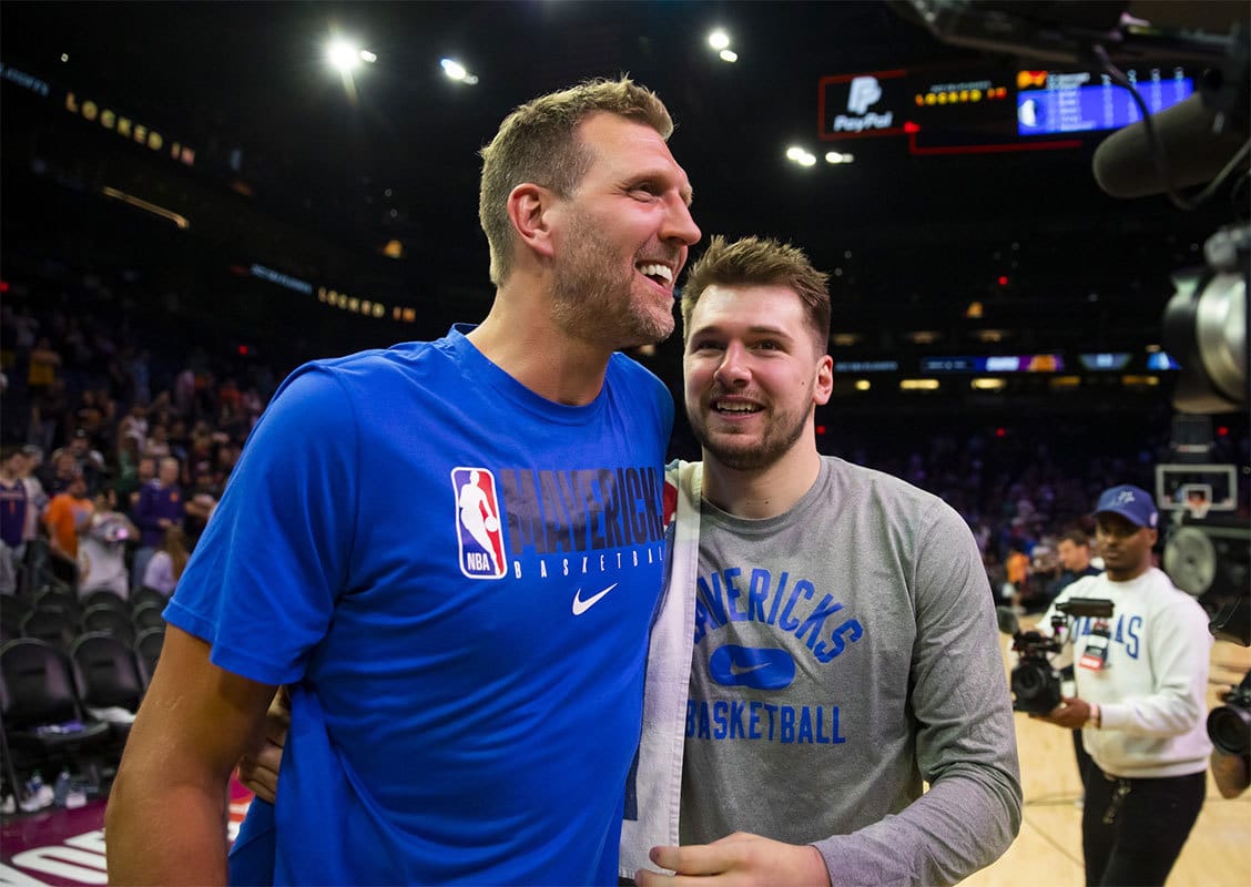 Dallas Mavericks guard Luka Doncic (right) with former player Dirk Nowitzki against the Phoenix Suns in game seven of the second round for the 2022 NBA playoffs at Footprint Center.