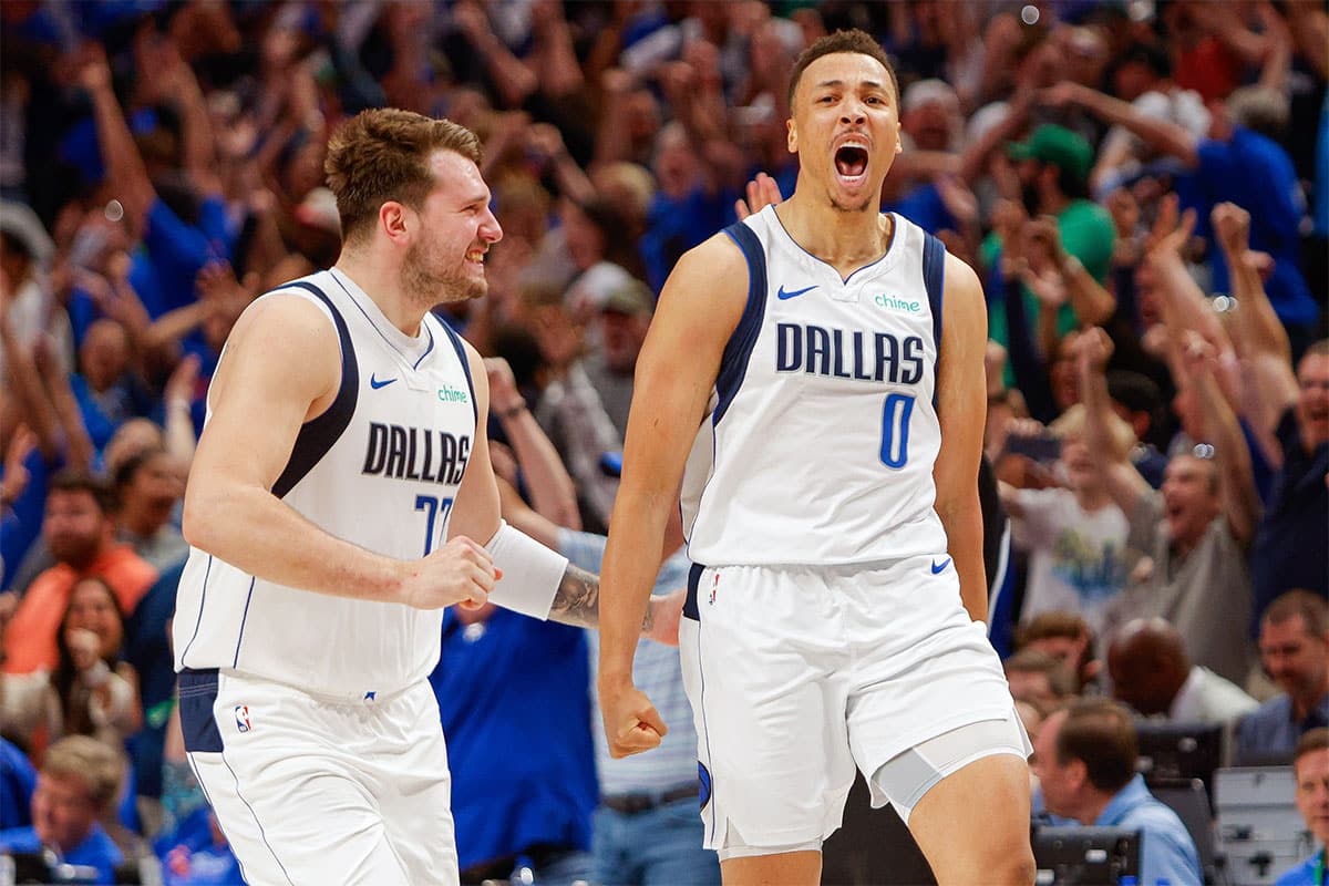 Dallas Mavericks guard Luka Doncic (77) celebrates with guard Dante Exum (0) making a three-pointer at the end of regulation against the Houston Rockets at American Airlines Center.