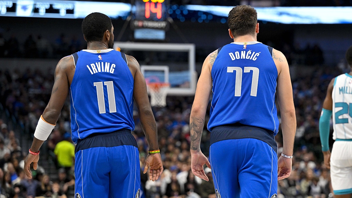 Dallas Mavericks guard Kyrie Irving (11) and guard Luka Doncic (77) walk back up the court during the second half against the Charlotte Hornets at the American Airlines Center.