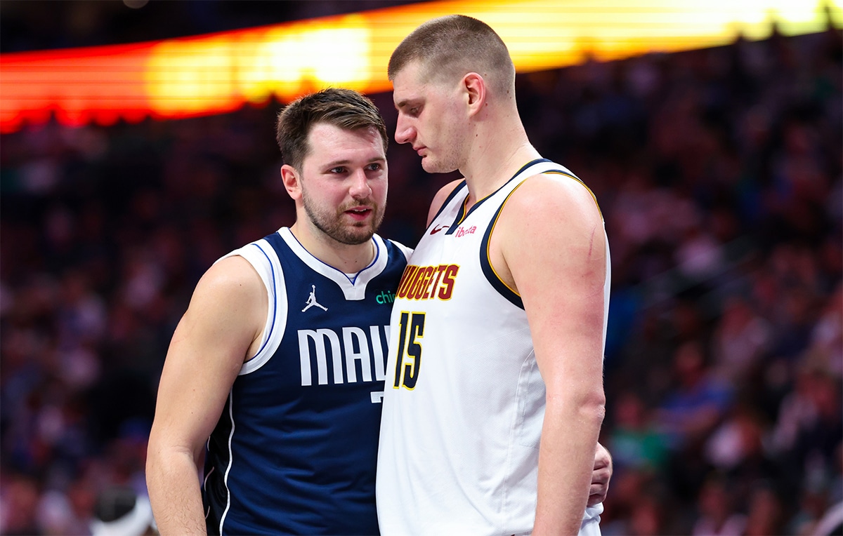 Dallas Mavericks guard Luka Doncic (77) speaks with Denver Nuggets center Nikola Jokic (15) during the second half at American Airlines Center.