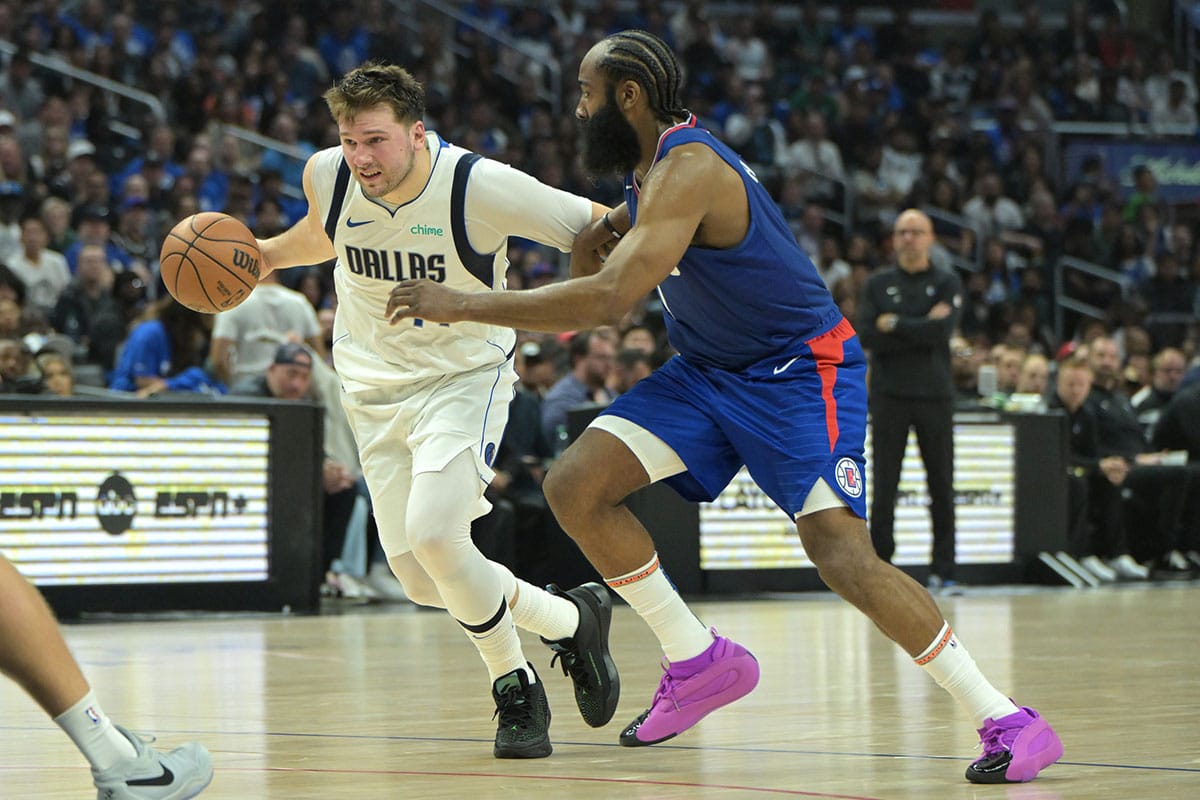 Dallas Mavericks guard Luka Doncic (77) is defended by Los Angeles Clippers guard James Harden (1) in the second half of game one of the first round for the 2024 NBA playoffs at Crypto.com Arena. 