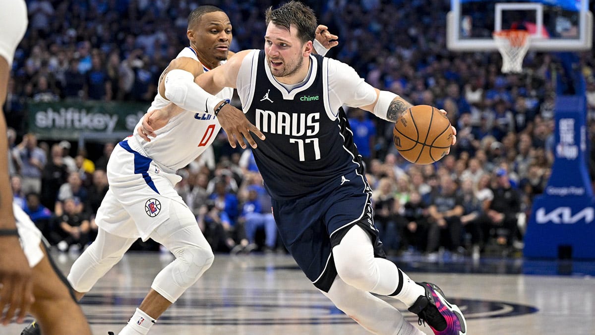 Dallas Mavericks guard Luka Doncic (77) is fouled by LA Clippers guard Russell Westbrook (0) during the fourth quarter during game three of the first round for the 2024 NBA playoffs at the American Airlines Center.