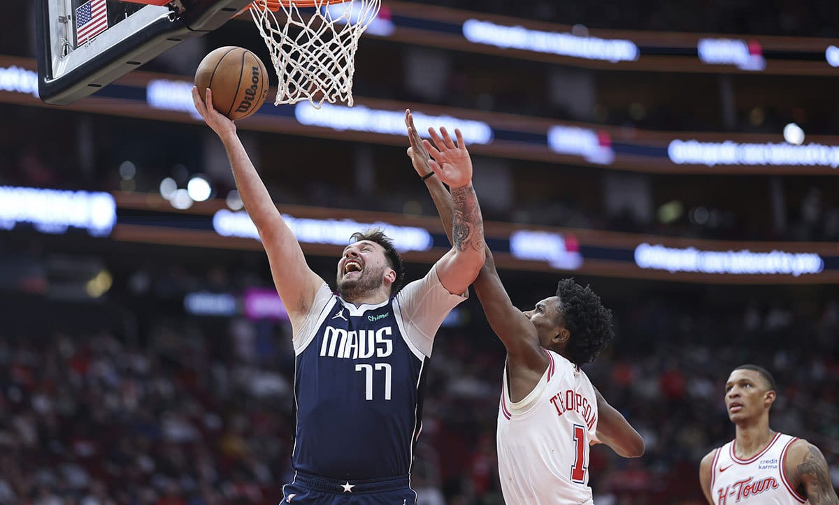 Dallas Mavericks guard Luka Doncic (77) shoots the ball as Houston Rockets forward Amen Thompson (1) defends during the third quarter at Toyota Center.