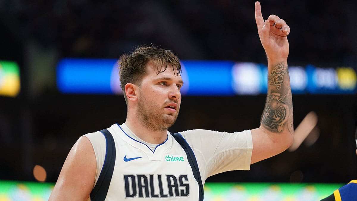 Dallas Mavericks guard Luka Doncic (77) holds up his hand before heading towards the team bench against the Golden State Warriors in the third quarter at the Chase Center.