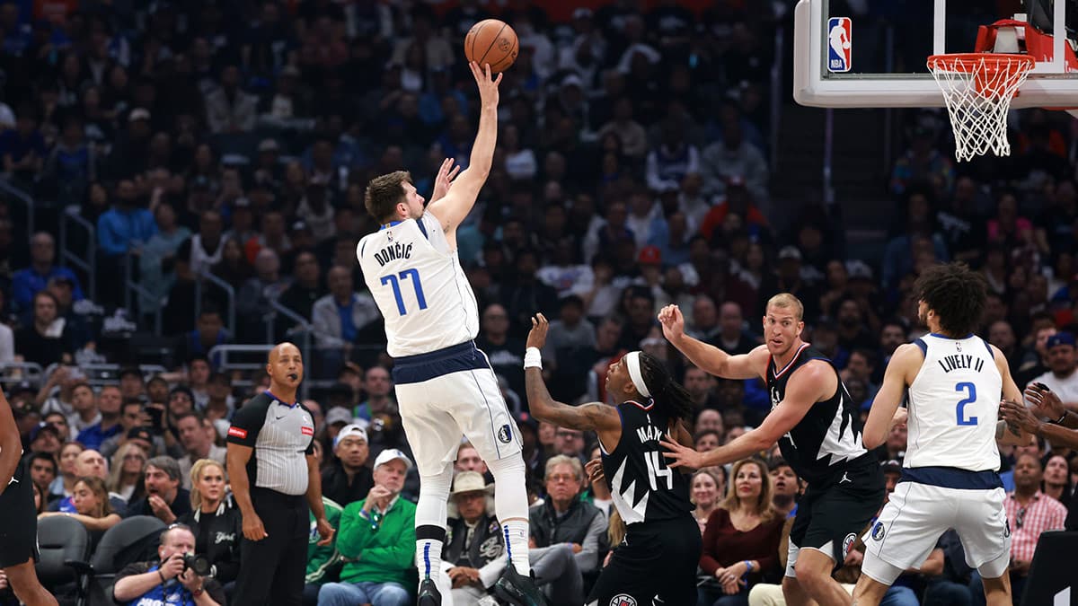 Dallas Mavericks guard Luka Doncic (77) shoots the ball over Los Angeles Clippers guard Terance Mann (14) during the first quarter of game two of the first round for the 2024 NBA playoffs at Crypto.com Arena.