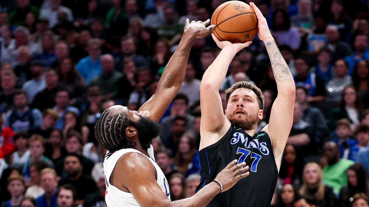 Dallas Mavericks guard Luka Doncic (77) shoots over LA Clippers guard James Harden (1) during the second quarter at American Airlines Center. 