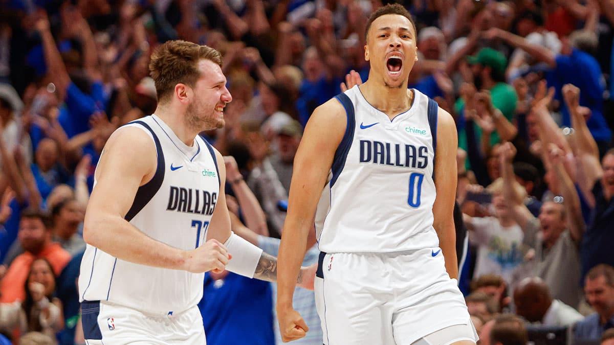 Dallas Mavericks guard Luka Doncic (77) celebrates with guard Dante Exum (0) making a three-pointer at the end of regulation against the Houston Rockets at American Airlines Center. 
