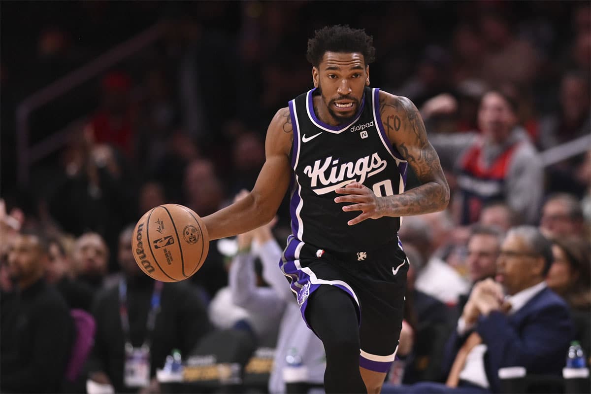 Sacramento Kings guard Malik Monk (0) dribbles top the court during the first half against the Washington Wizards at Capital One Arena.