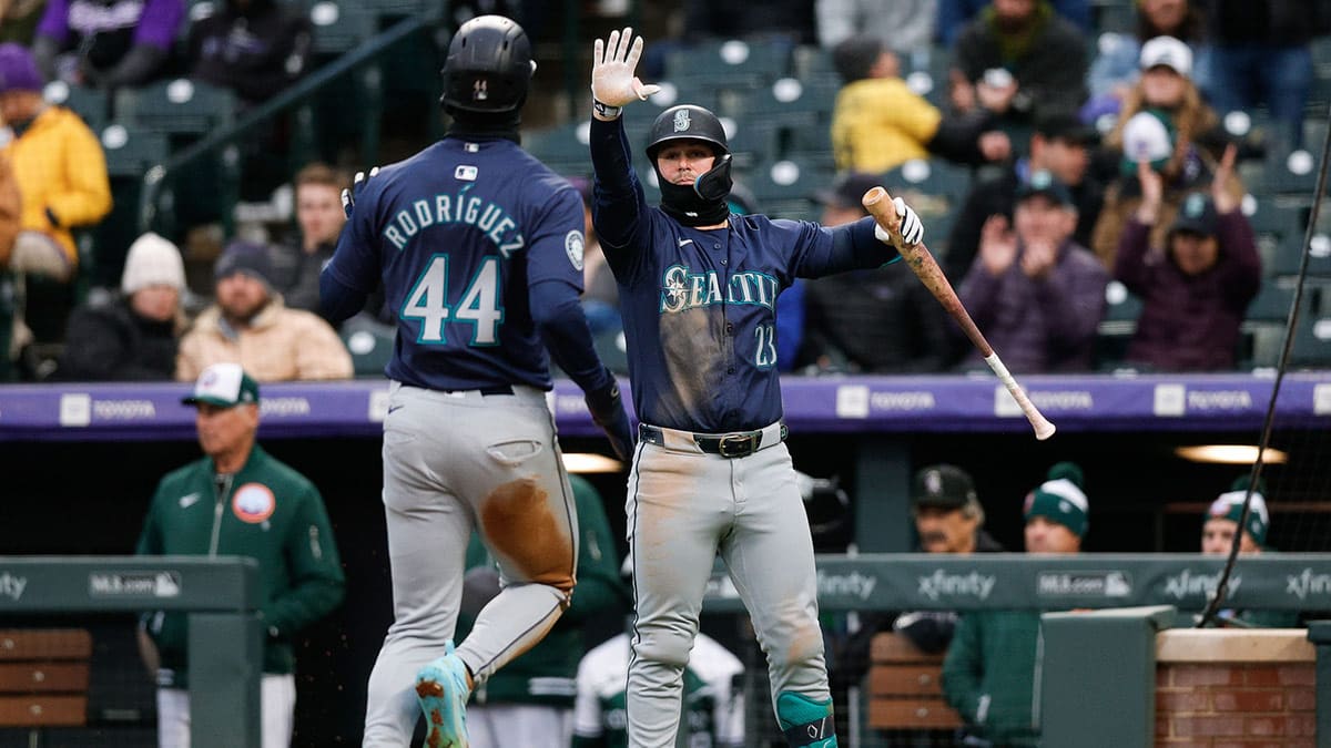 Seattle Mariners first baseman Ty France (23) reacts after center fielder Julio Rodriguez (44) scores on an RBI in the third inning against the Colorado Rockies at Coors Field. 