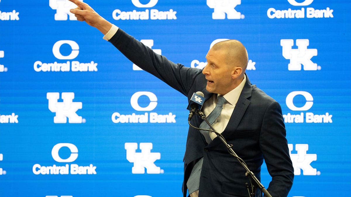 University of Kentucky’s new men’s basketball coach Mark Pope points to the championship banners as he speaks about the victories he will soon be adding to display.