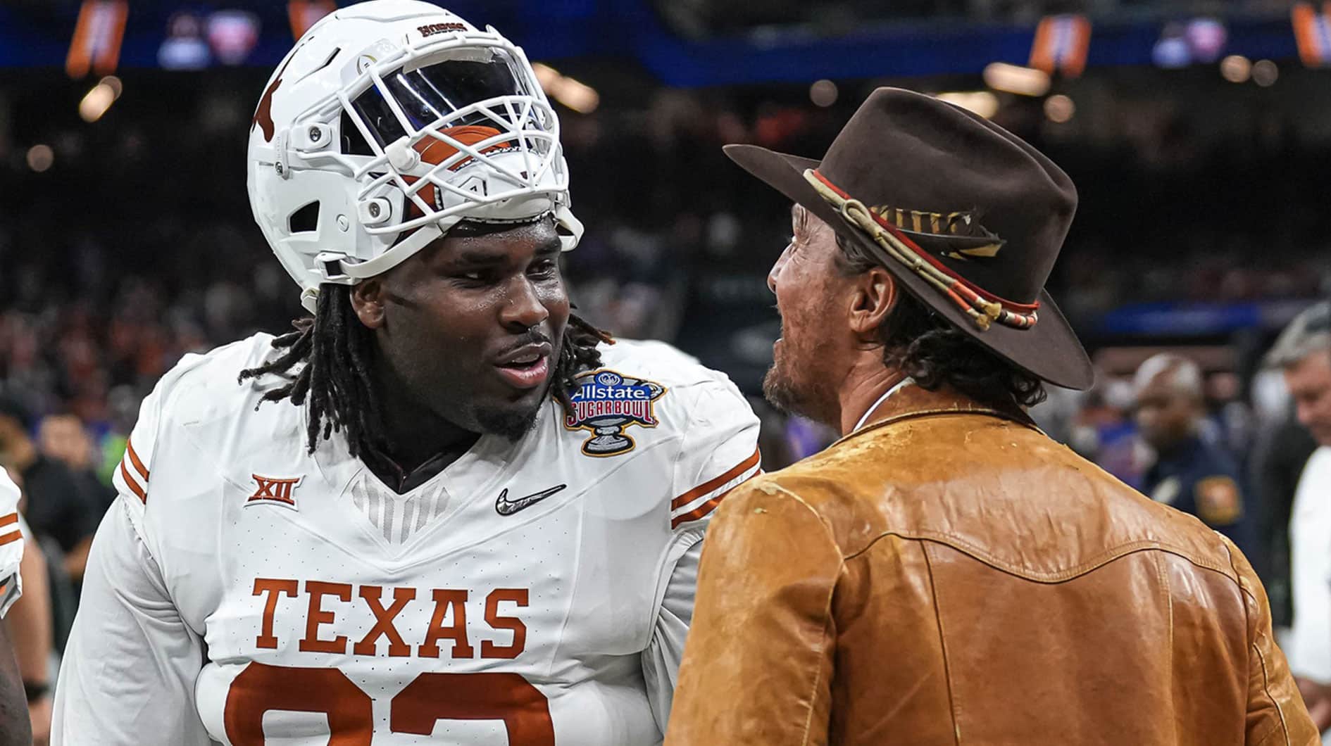 Matthew McConaughey talks to Texas Longhorns defensive lineman T'Vondre Sweat (93) ahead of the Sugar Bowl College Football Playoff semifinals game against the Washington Huskies at the Caesars Superdome on Monday