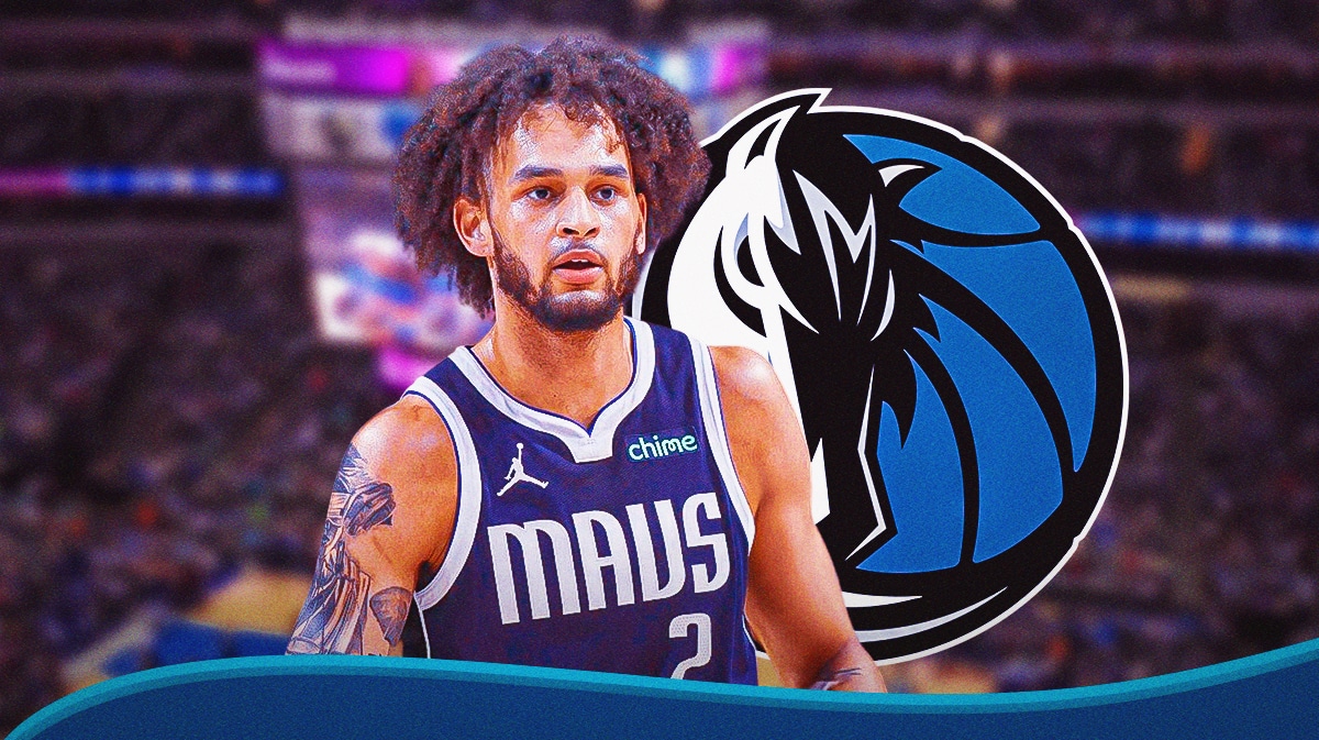 Mavericks' Dereck Lively II looking serious in front with Mavericks' logo in background.