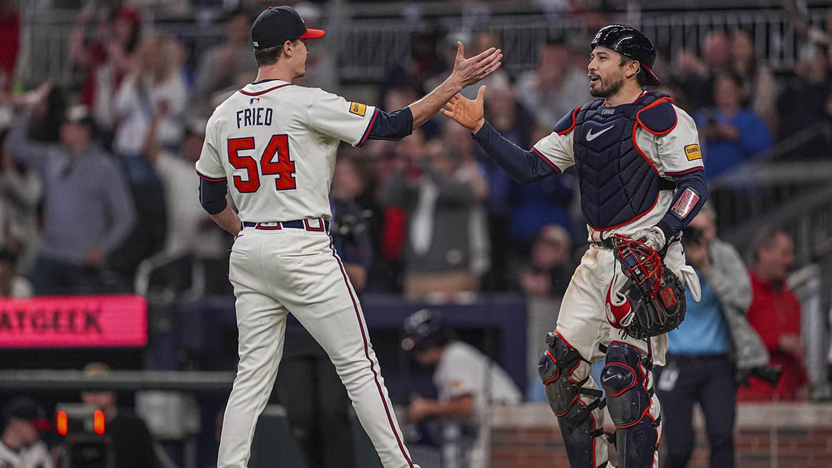Atlanta Braves pitcher Max Fried (54) reacts with catcher Travis d'Arnaud (16) after pitching a complete game shutout against the Miami Marlins at Truist Park.