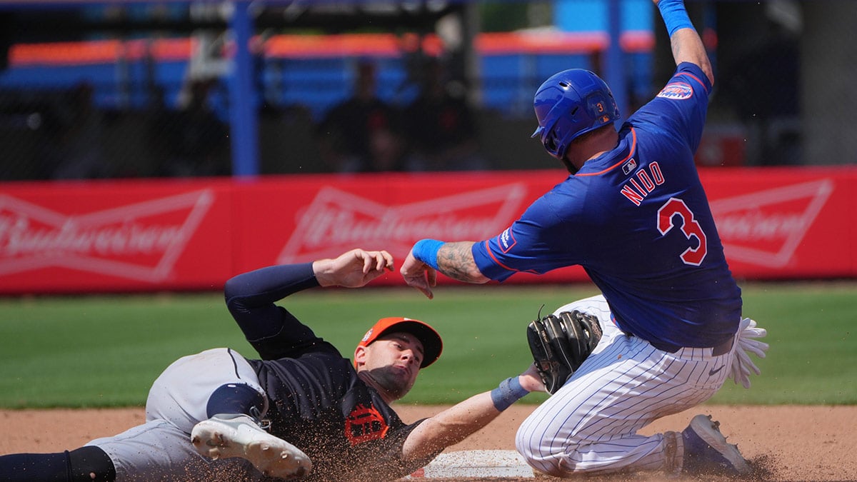 New York Mets catcher Tomas Nido (3) gets tagged out at second base by Detroit Tigers shortstop Ryan Kreidler (32) in the seventh inning Clover Park.