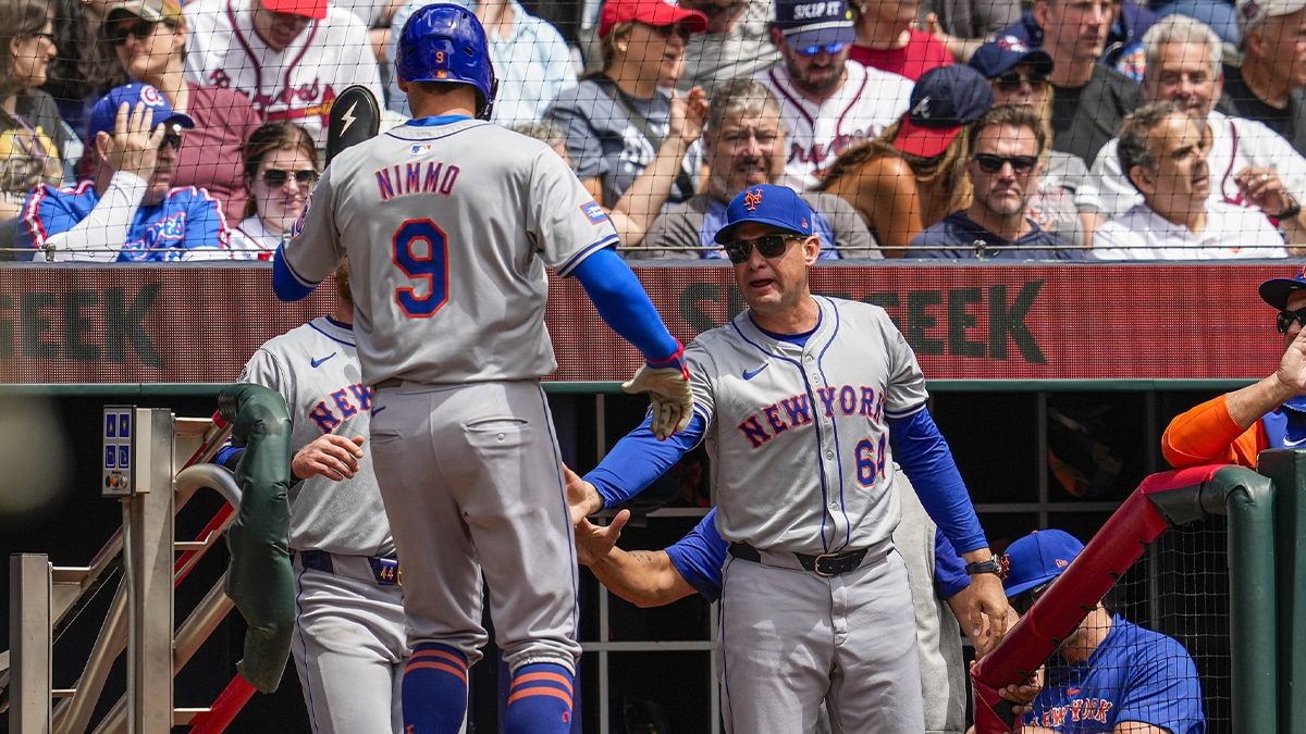 Mets left fielder Brandon Nimmo (9) reacts with manager Carlos Mendoza (64)