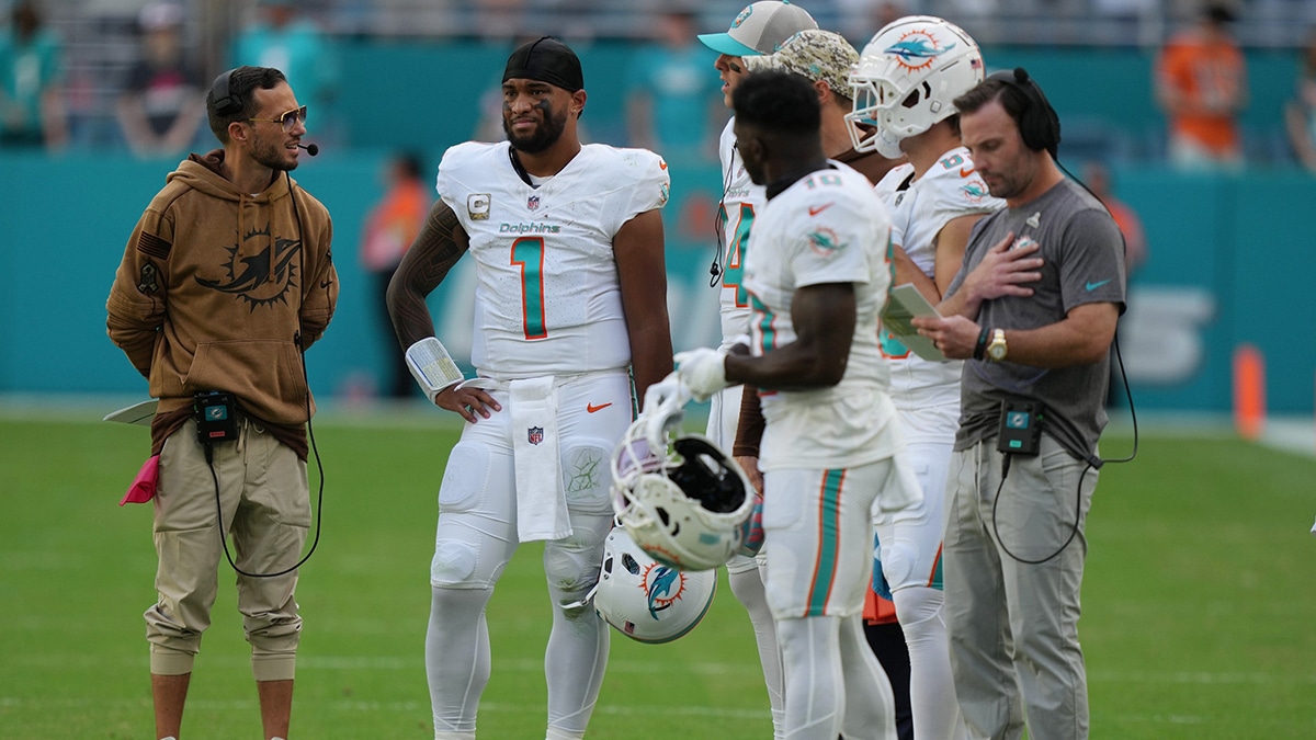 Miami Dolphins head coach Mike McDaniel talks with quarterback Tua Tagovailoa (1) during the first half of an NFL game against the Las Vegas Raiders at Hard Rock Stadium in Miami Gardens, Nov. 19, 2023.