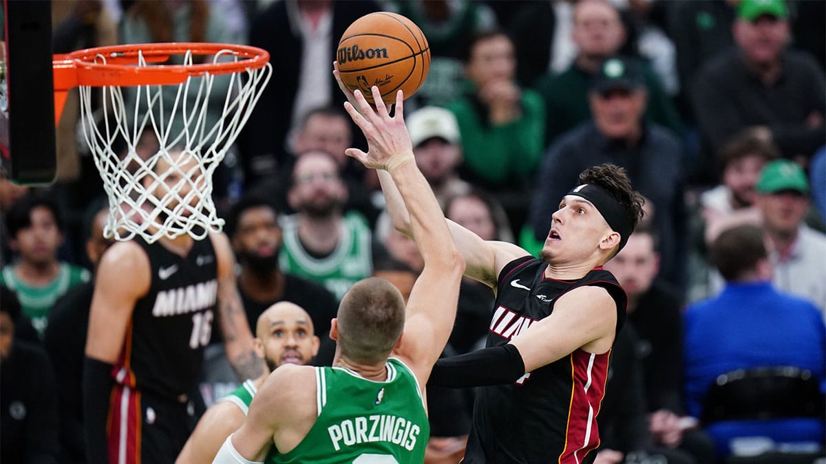 Apr 24, 2024; Boston, Massachusetts, USA; Miami Heat guard Tyler Herro (14) drives to the basket against Boston Celtics center Kristaps Porzingis (8) in the second half during game two of the first round for the 2024 NBA playoffs at TD Garden. Mandatory Credit: David Butler II-USA TODAY Sports