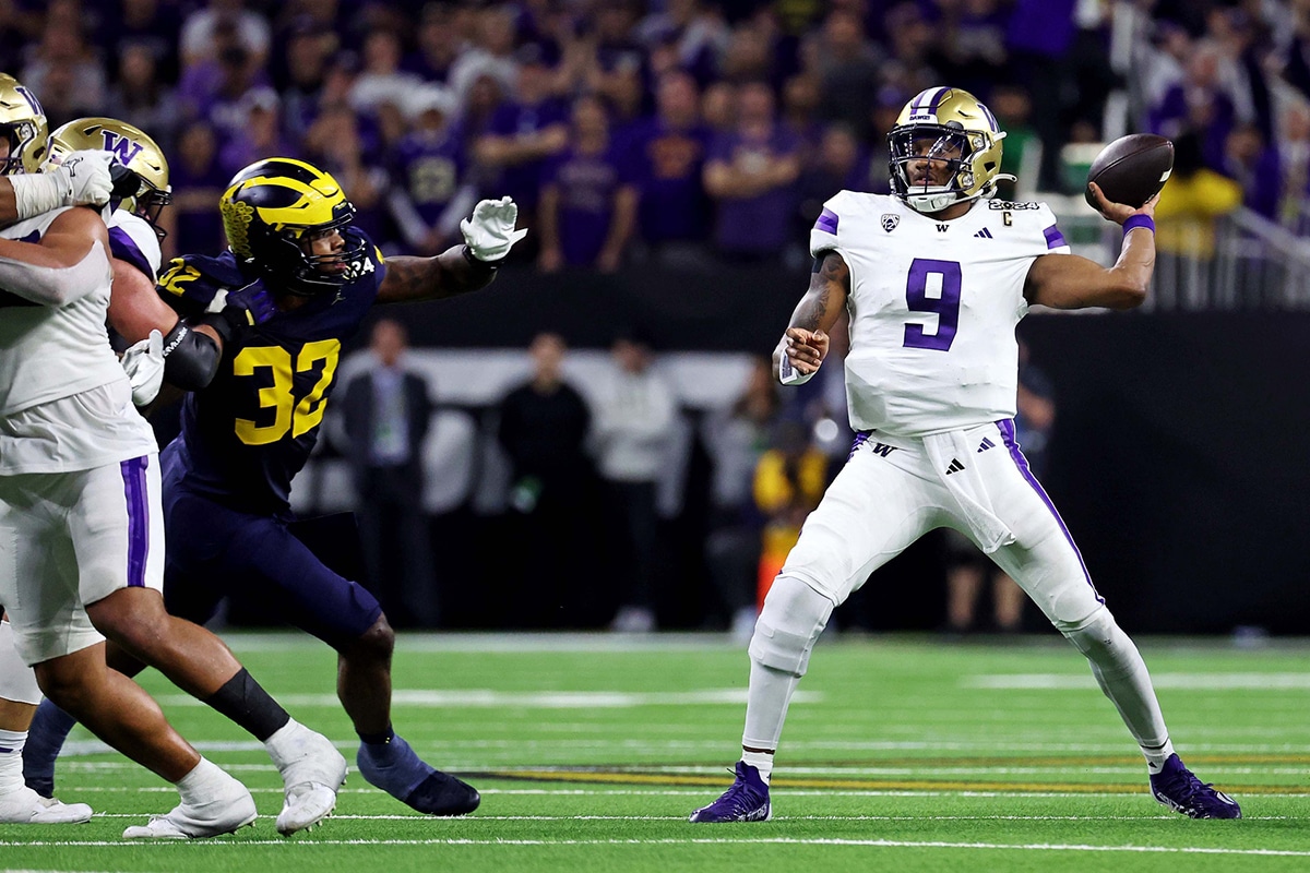 Washington Huskies quarterback Michael Penix Jr. (9) throws a pass against Michigan Wolverines linebacker Jaylen Harrell (32) during the fourth quarter in the 2024 College Football Playoff national championship game at NRG Stadium. 