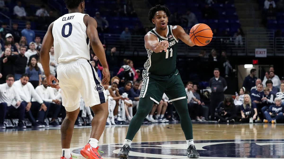 Michigan State Spartans guard AJ Hoggard (11) passes the ball as Penn State Nittany Lions guard Kanye Clary (0) defends during the second half at Bryce Jordan Center. Michigan State defeated Penn State 80-72. 
