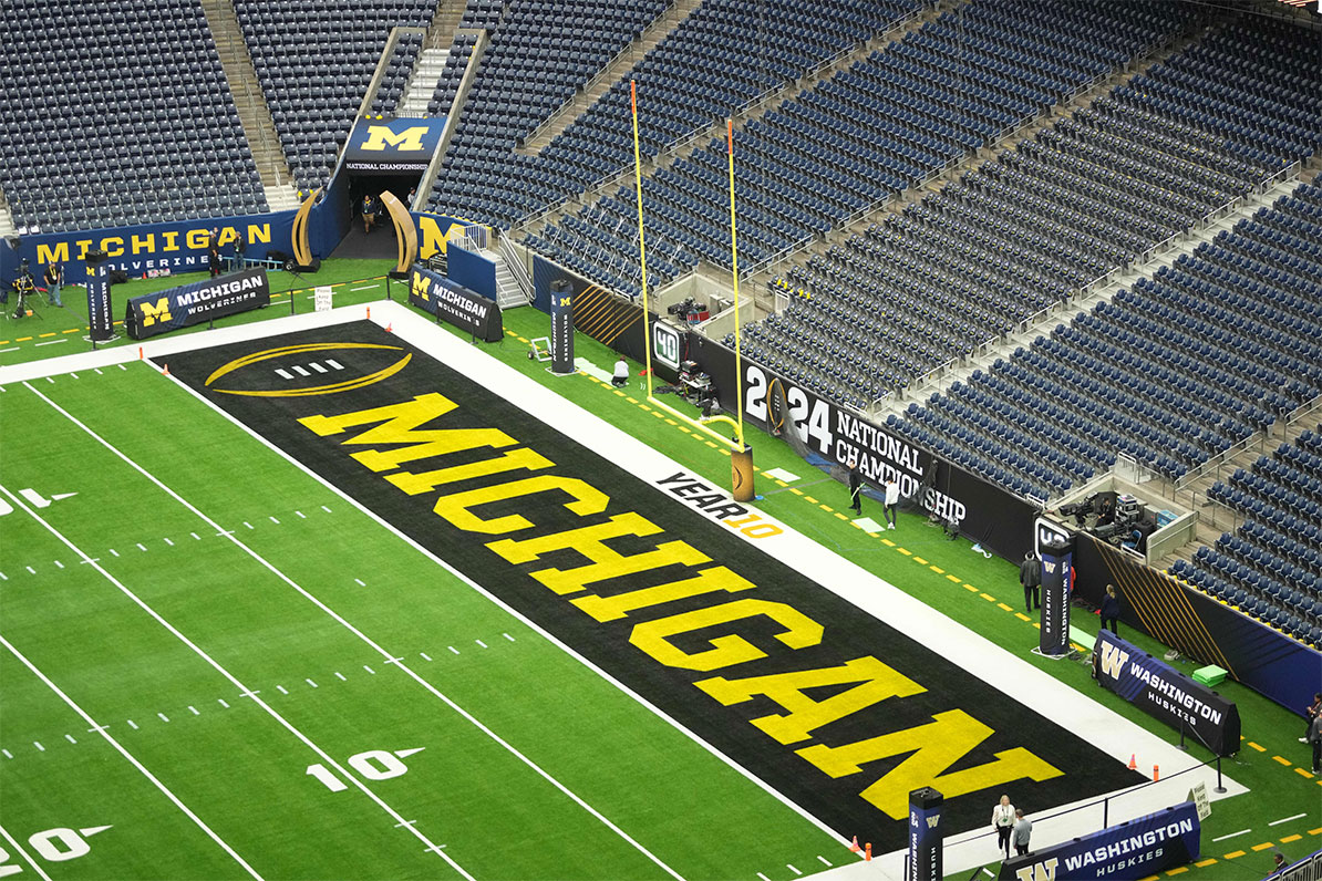 The Michigan Wolverines logo in the end zone before the 2024 College Football Playoff national championship game between the Michigan Wolverines and the Washington Huskies at NRG Stadium. 