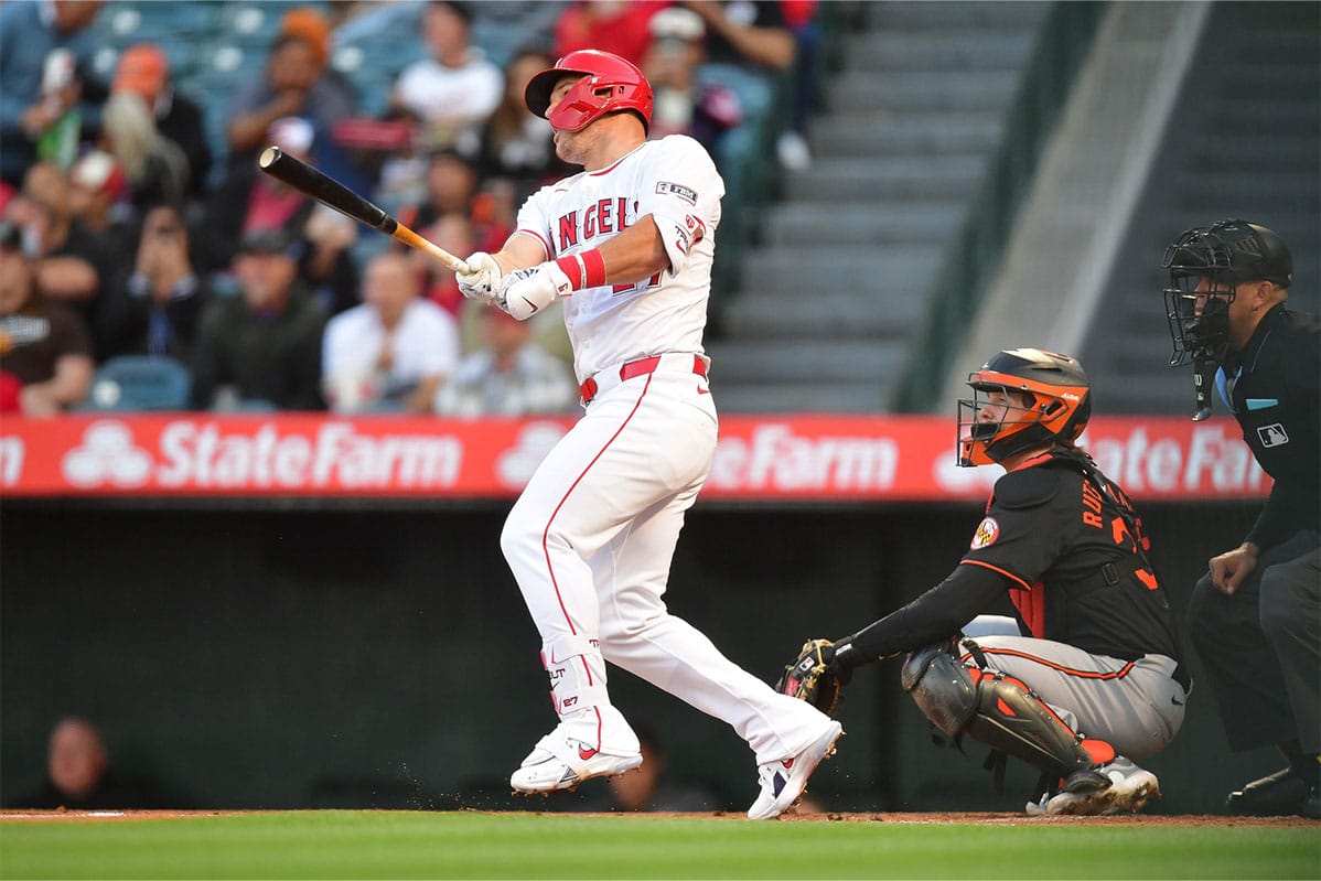 Los Angeles Angels center fielder Mike Trout (27) hits a solo home run against the Baltimore Orioles during the first inning at Angel Stadium. 