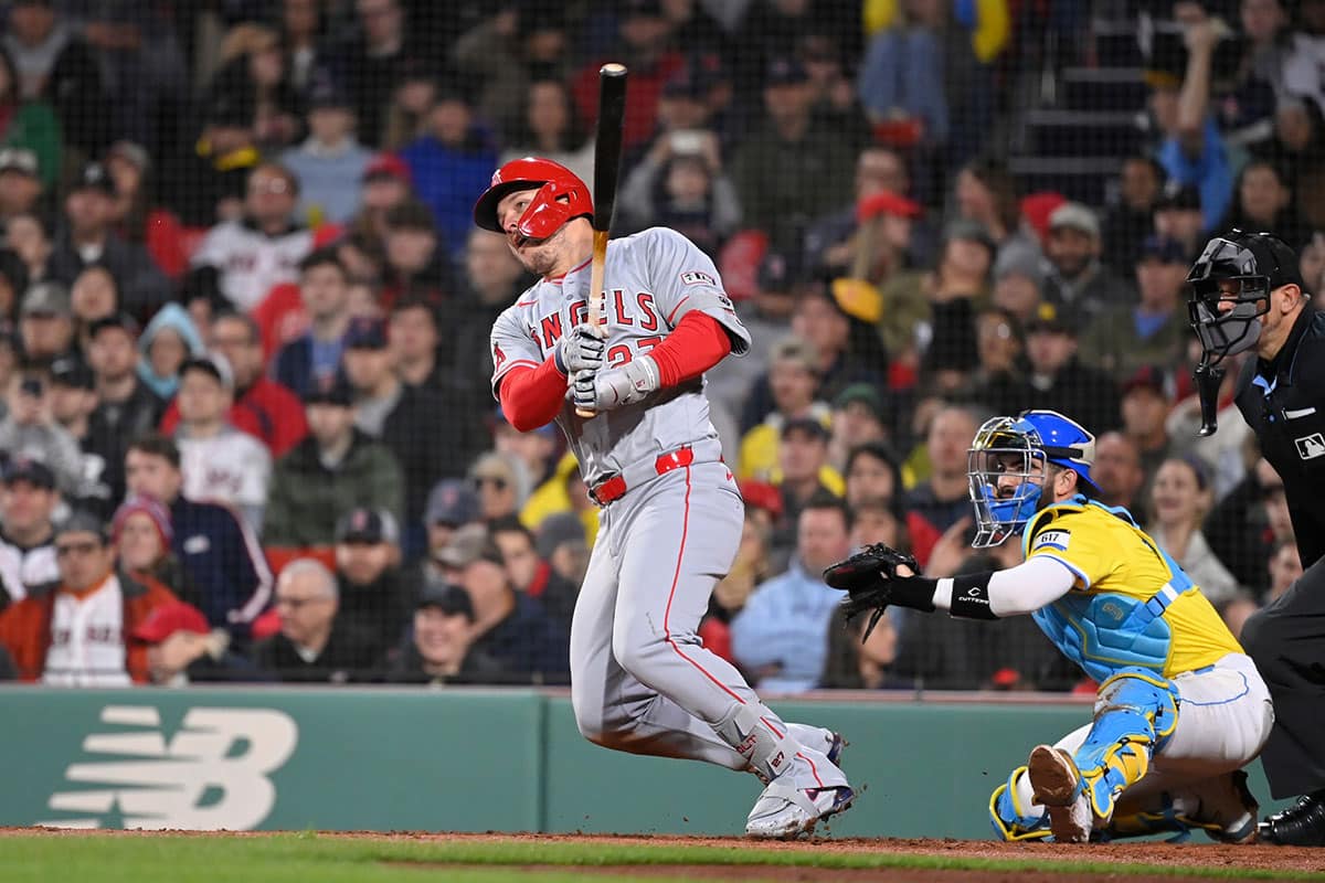 Los Angeles Angels center fielder Mike Trout (27) hits a single during the sixth inning against the Boston Red Sox at Fenway Park. 