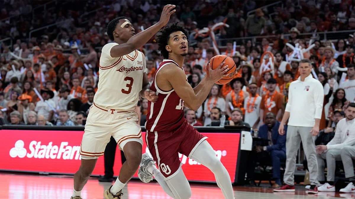 Oklahoma Sooners guard Milos Uzan (12) drives to the basket while defended by Texas Longhorns guard Max Abmas (3) during the second half at Moody Center.