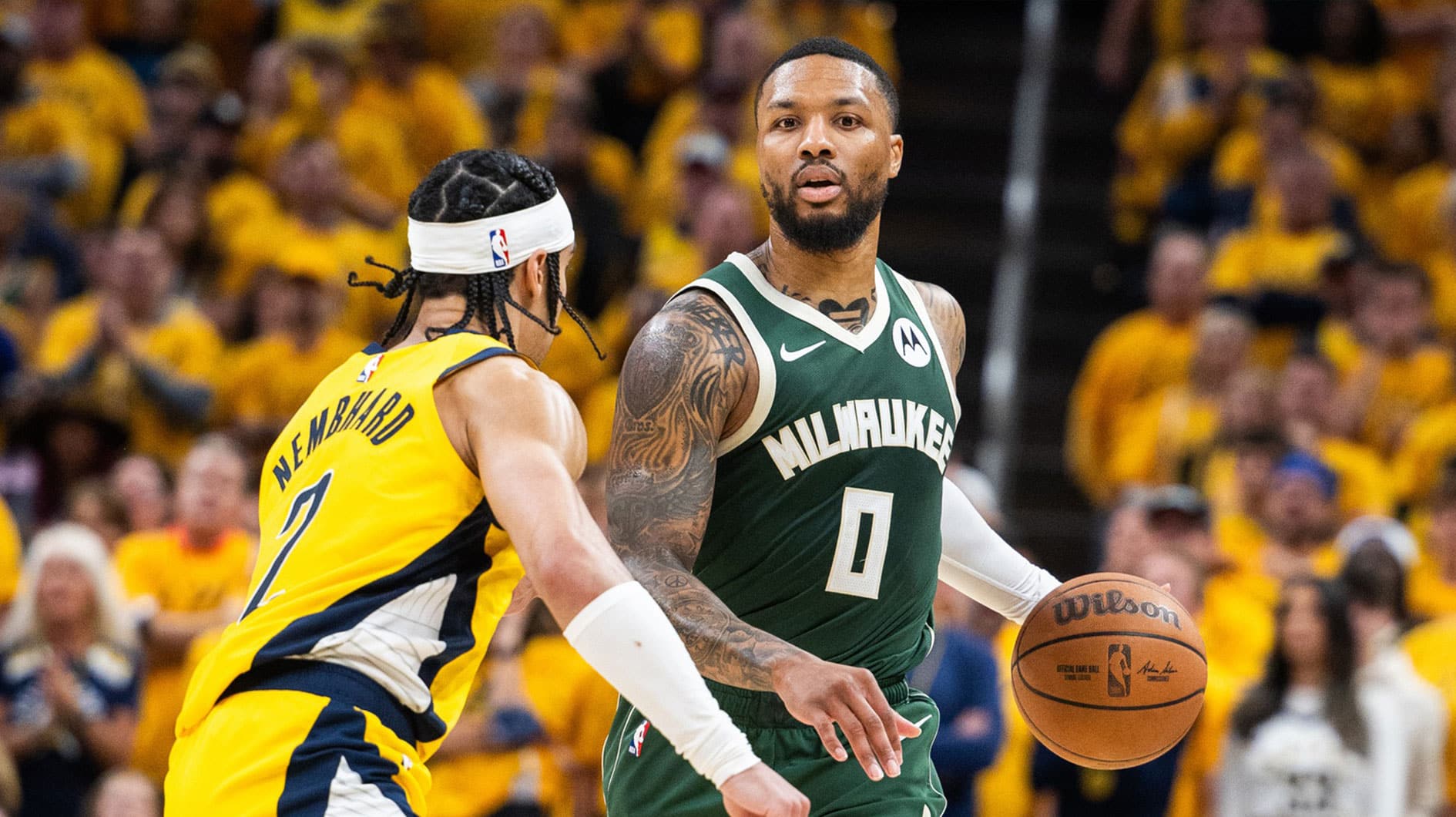 Apr 26, 2024; Indianapolis, Indiana, USA; Milwaukee Bucks guard Damian Lillard (0) dribbles the ball while Indiana Pacers guard Andrew Nembhard (2) defends during game three of the first round for the 2024 NBA playoffs at Gainbridge Fieldhouse. Mandatory Credit: Trevor Ruszkowski-USA TODAY Sports
