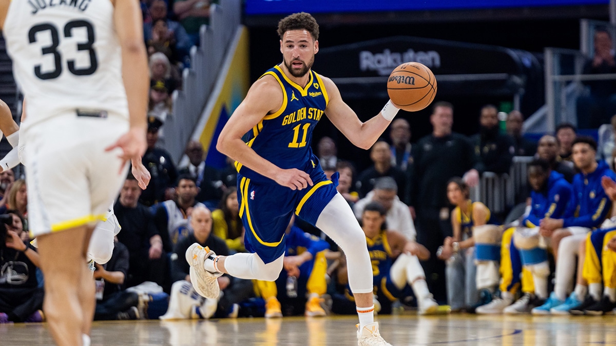 Golden State Warriors guard Klay Thompson (11) dribbles the ball during the first quarter against the Utah Jazz at Chase Center.