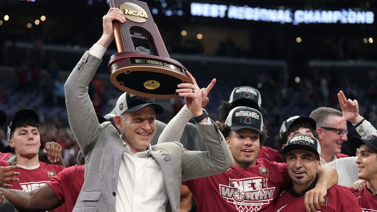 Alabama Crimson Tide head coach Nate Oats celebrates with the trophy after defeating the Clemson Tigers in the finals of the West Regional of the 2024 NCAA Tournament at Crypto.com Arena