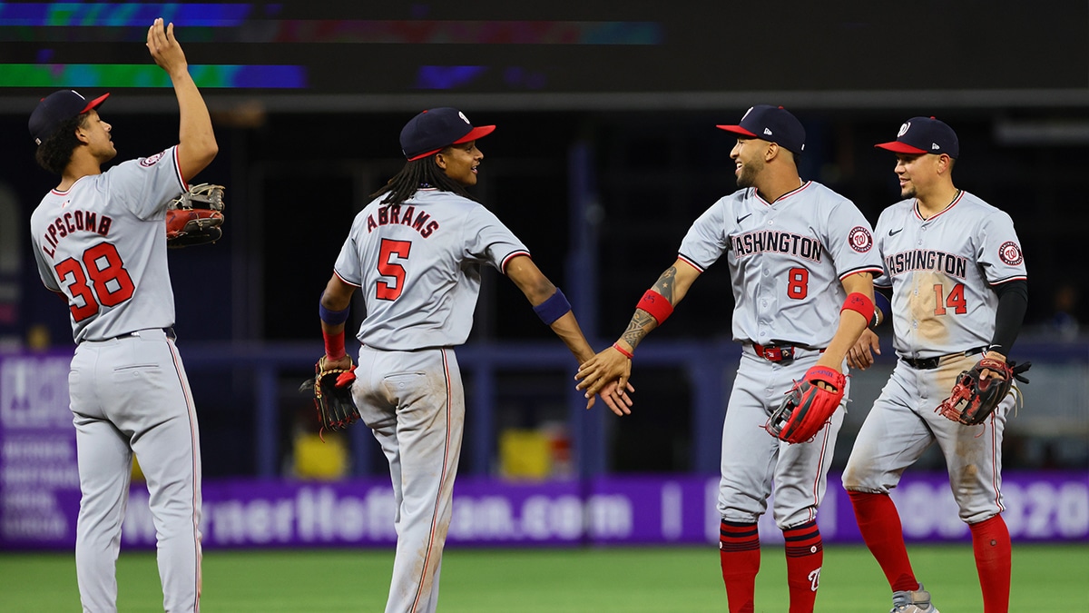 Washington Nationals shortstop CJ Abrams (5) celebrates with right fielder Eddie Rosario (8) and second baseman Ildemaro Vargas (14) after the game against the Miami Marlins at loanDepot Park.