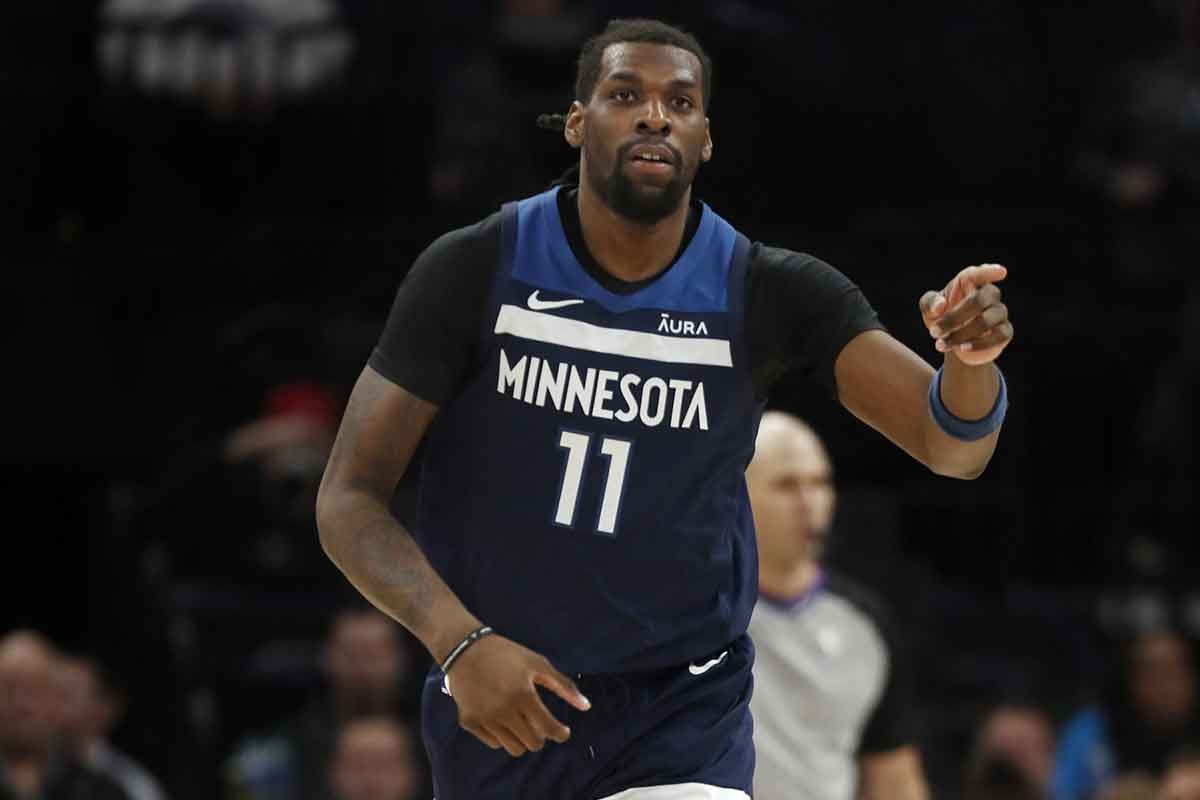 Minnesota Timberwolves center Naz Reid (11) thanks his teammate after scoring against the Orlando Magic in the third quarter at Target Center.