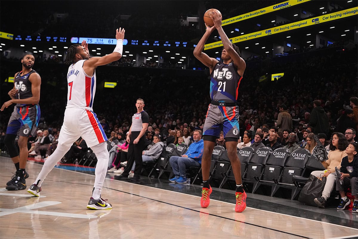 Brooklyn Nets forward Noah Clowney (21) shoots a three-point jump shot over Detroit Pistons small forward Troy Brown Jr. (7) during the second half at Barclays Center. 