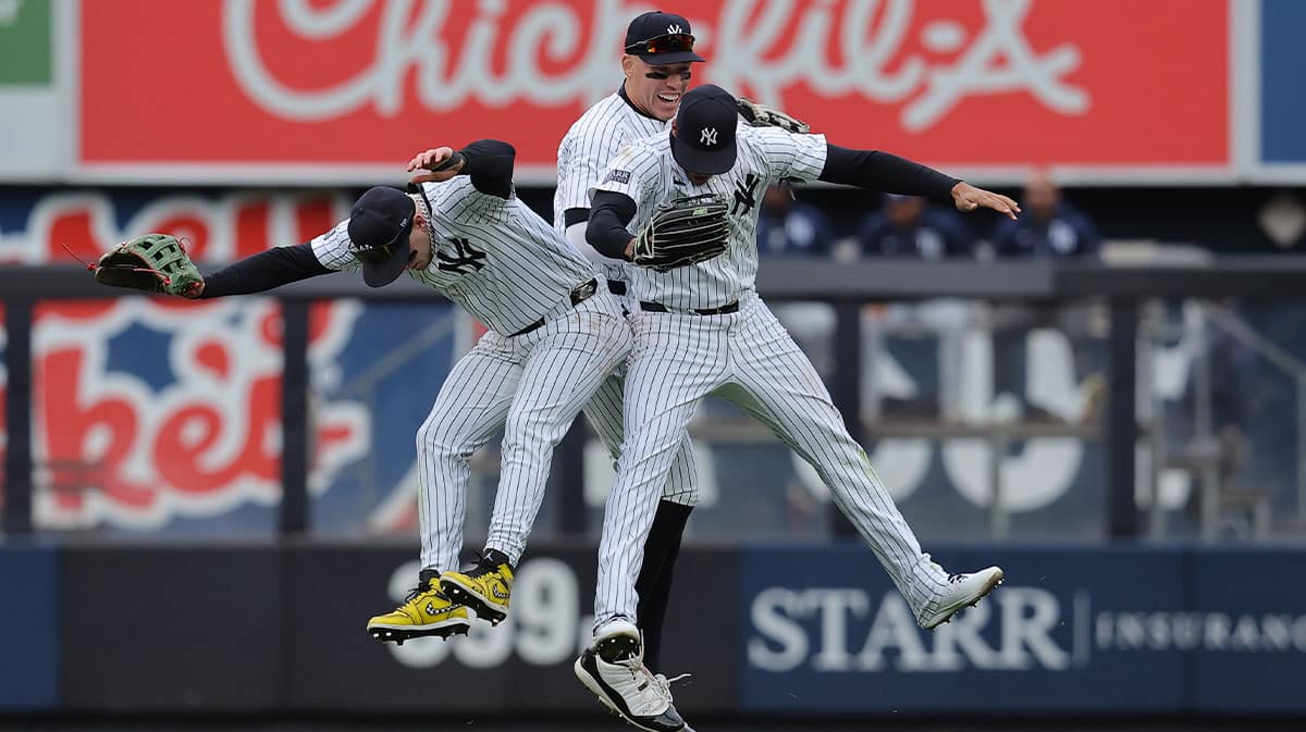 New York Yankees left fielder Alex Verdugo (24) and center fielder Aaron Judge (99) and right fielder Juan Soto (22) celebrate after defeating the Tampa Bay Rays at Yankee Stadium. 