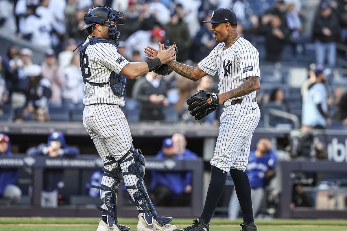 New York Yankees relief pitcher Dennis Santana (53) celebrates with catcher Austin Wells (28) after defeating the Toronto Blue Jays at Yankee Stadium. 