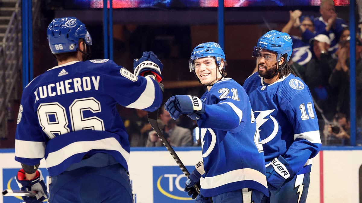 Tampa Bay Lightning center Brayden Point (21) is congratulated by right wing Nikita Kucherov (86) and left wing Anthony Duclair (10) after he scored against the Columbus Blue Jackets during the first period at Amalie Arena.