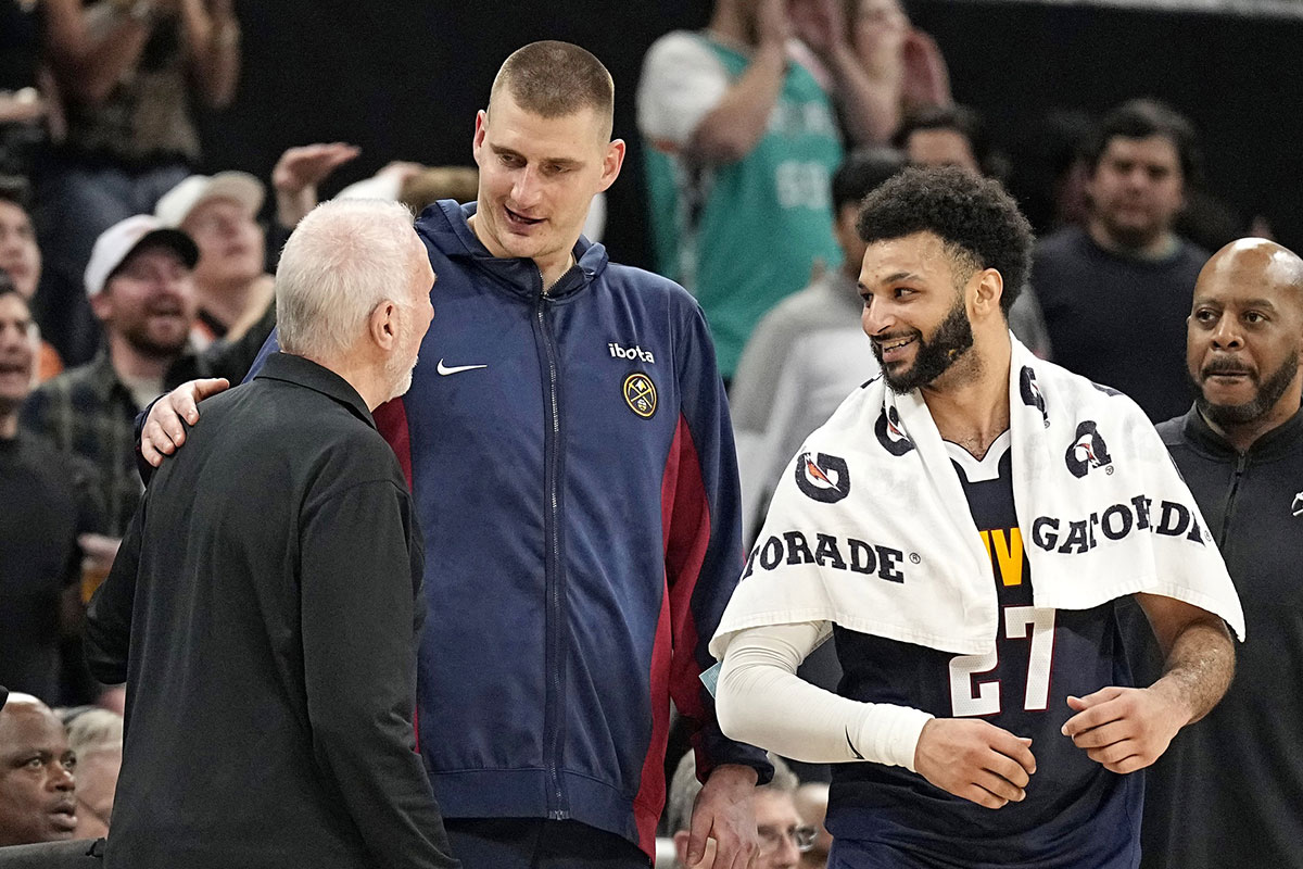 Denver Nuggets center Nikola Jokic (15) and guard Jamal Murray (27) greet with San Antonio Spurs head coach Gregg Popovich after a game at Moody Center.