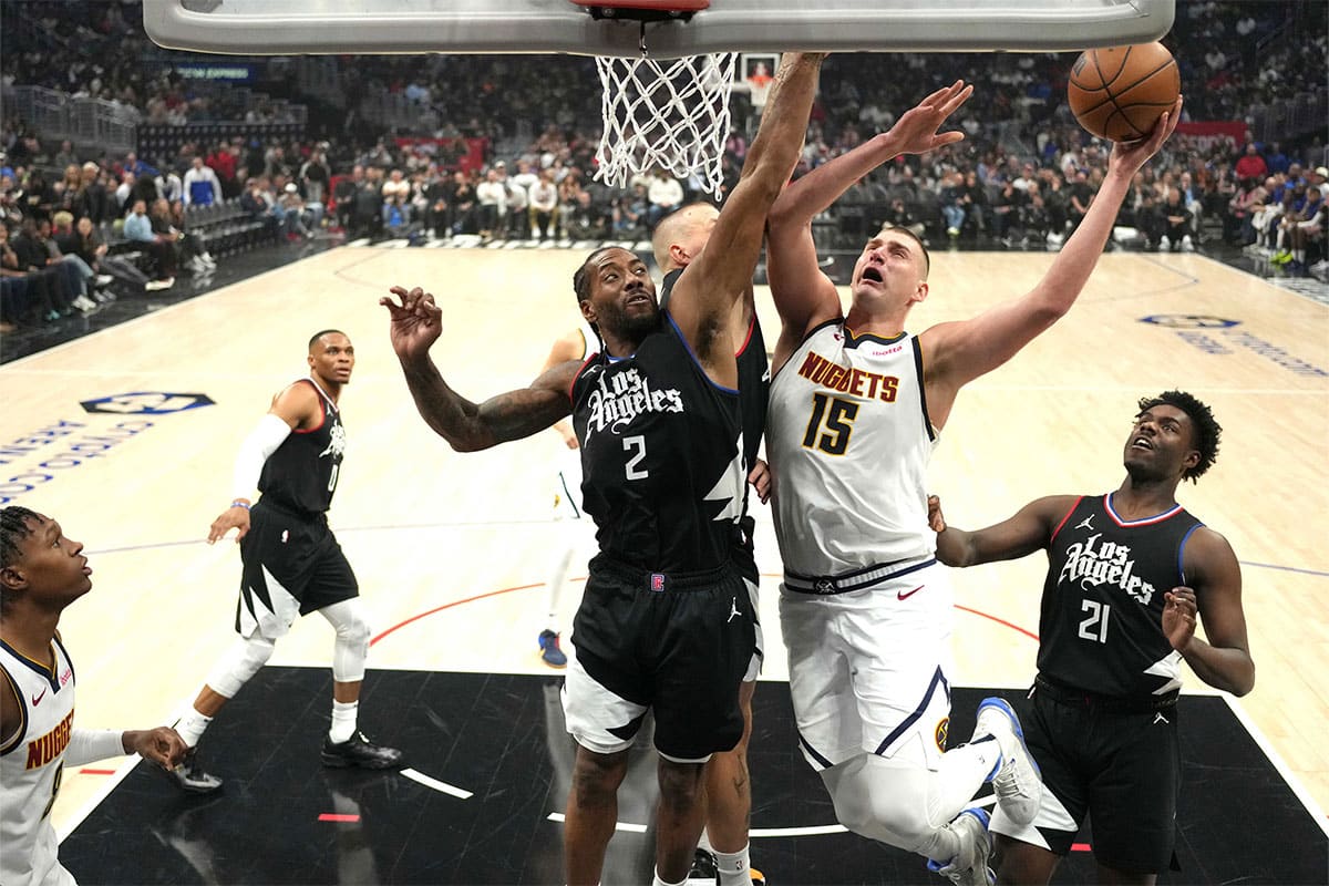 Denver Nuggets center Nikola Jokic (15) shoots the ball against LA Clippers forward Kawhi Leonard (2) and center Ivica Zubac (40) in the first half at Crypto.com Arena.