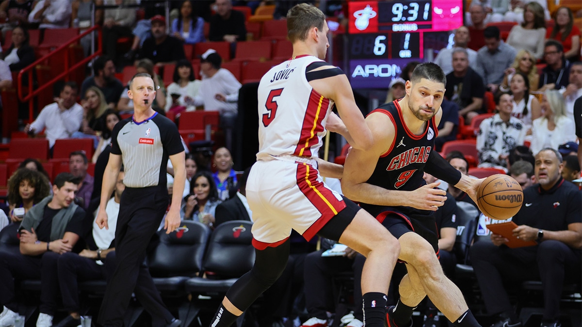 Chicago Bulls center Nikola Vucevic (9) drives to the basket against Miami Heat forward Nikola Jovic (5) in the first quarter during a play-in game of the 2024 NBA playoffs at Kaseya Center.