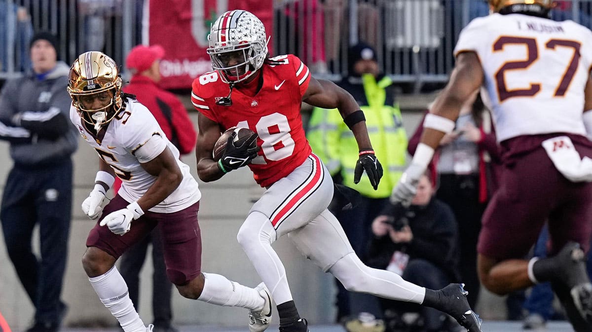 Ohio State Buckeyes wide receiver Marvin Harrison Jr. (18) runs past Minnesota Golden Gophers defensive back Justin Walley (5) after making a catch during the first half of the NCAA football game at Ohio Stadium.