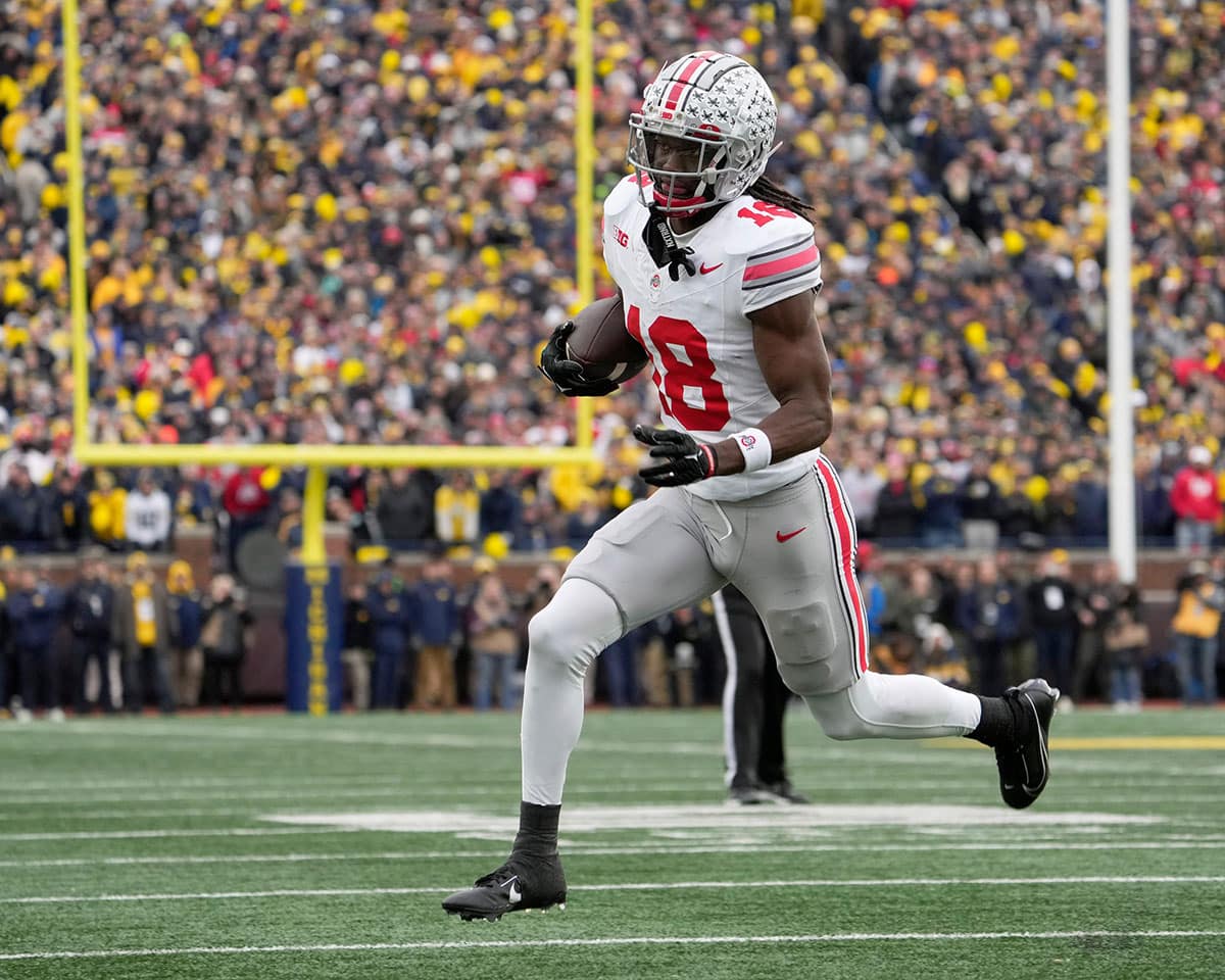 Ohio State Buckeyes wide receiver Marvin Harrison Jr. (18) toward the end zone during the second half of Saturday's NCAA Division I football game against the University of Michigan.