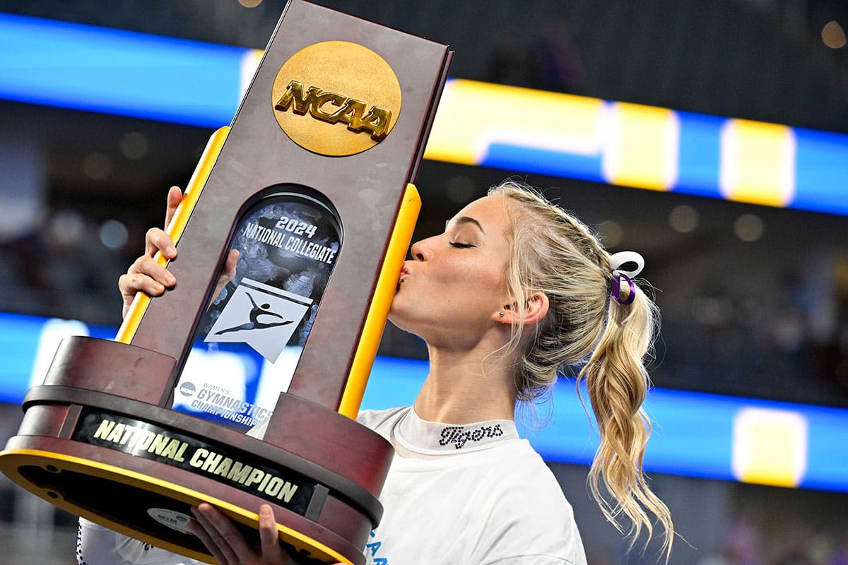 LSU Tigers gymnast Olivia Dunne kisses the championship trophy after the LSU Tigers gymnastics team wins the national championship in the 2024 Womens National Gymnastics Championship.
