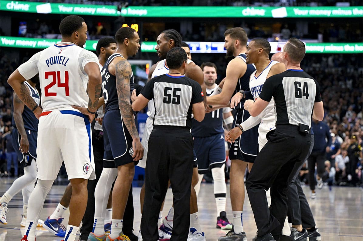The NBA referees separate Dallas Mavericks forward P.J. Washington (25) and LA Clippers guard Russell Westbrook (0) as they exchange words during the fourth quarter during game three of the first round for the 2024 NBA playoffs at the American Airlines Center.