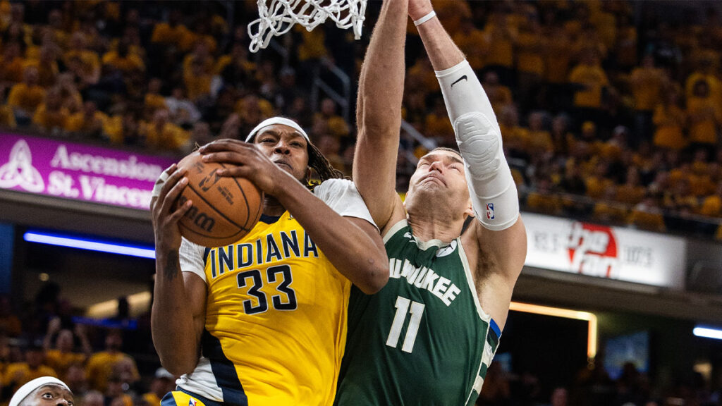 Pacers center Myles Turner (33) rebounds the ball over Milwaukee Bucks center Brook Lopez (11)