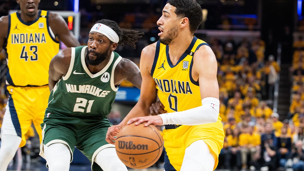 Pacers guard Tyrese Haliburton (0) dribbles the ball while Milwaukee Bucks guard Patrick Beverley (21) defends
