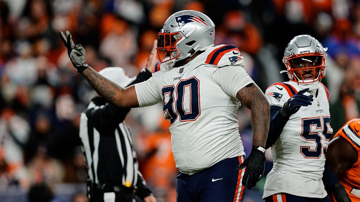 New England Patriots defensive tackle Christian Barmore (90) reacts after a play ]in the third quarter against the Denver Broncos at Empower Field at Mile High.