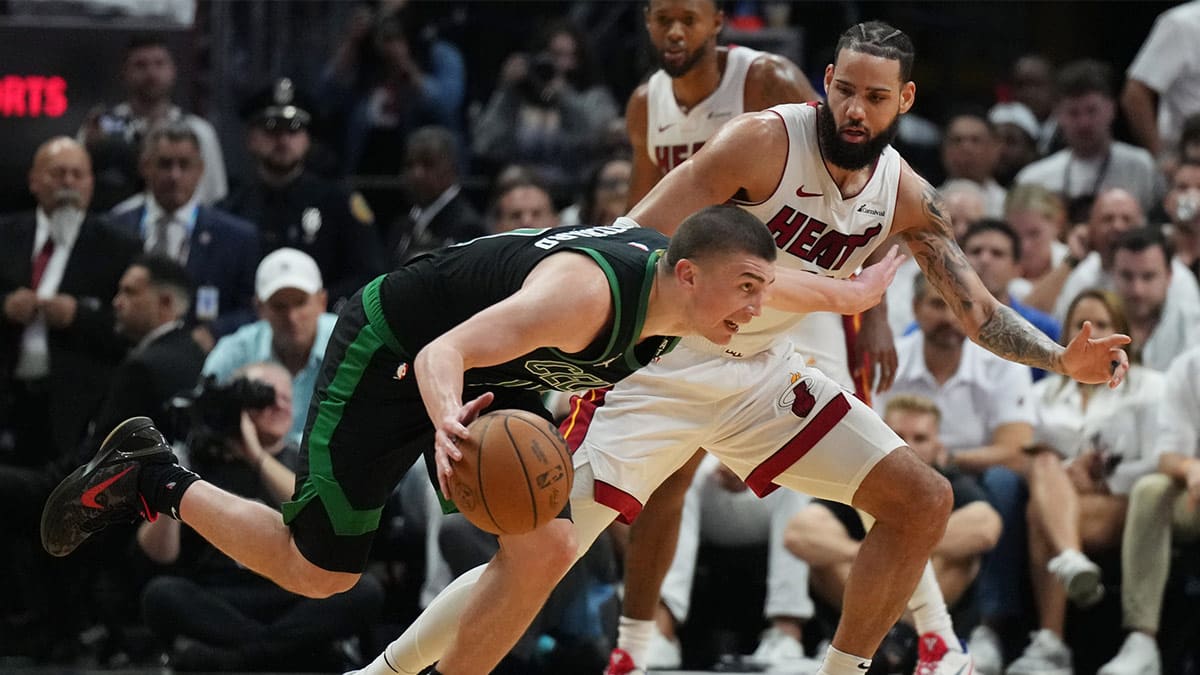 Boston Celtics guard Payton Pritchard (11) drives past Miami Heat forward Caleb Martin (16) in the first half during game three of the first round for the 2024 NBA playoffs at Kaseya Center.