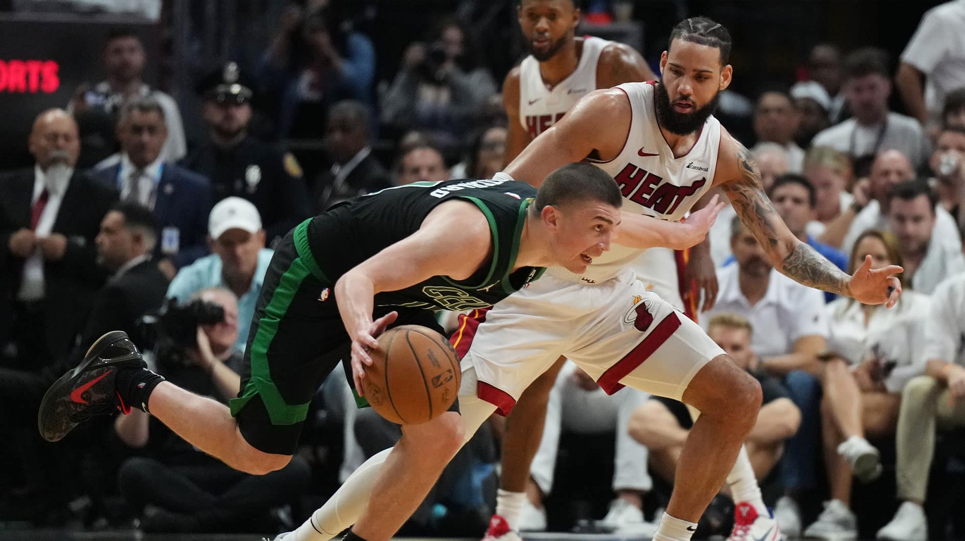 Boston Celtics guard Payton Pritchard (11) drives past Miami Heat forward Caleb Martin (16) in the first half during game three of the first round for the 2024 NBA playoffs at Kaseya Center. 