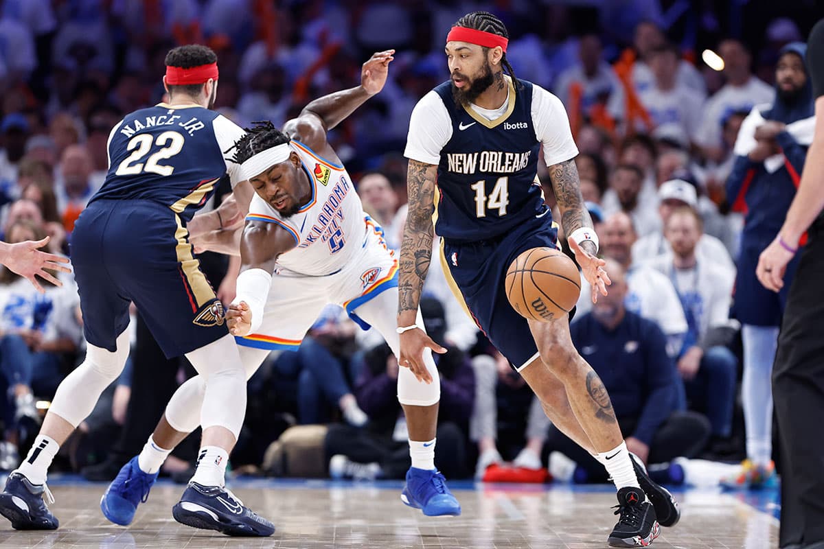 Oklahoma City, Oklahoma, USA; New Orleans Pelicans forward Brandon Ingram (14) drives around Oklahoma City Thunder guard Luguentz Dort (5) during the fourth quarter of game one of the first round for the 2024 NBA playoffs at Paycom Center.